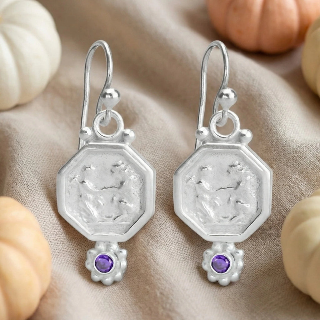 Handmade amethyst coin earrings with gold plating showing artisan craftsmanship and vintage bronze coin design
