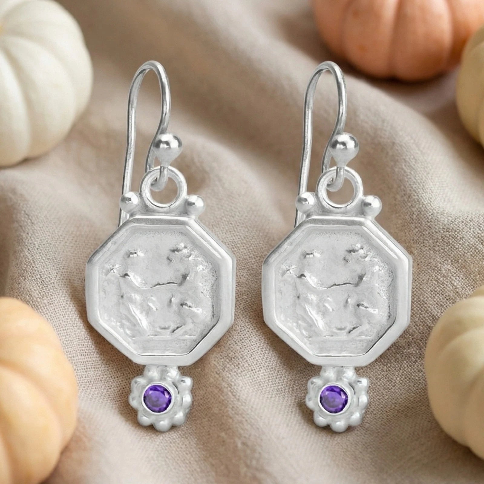 Handmade amethyst coin earrings with gold plating showing artisan craftsmanship and vintage bronze coin design
