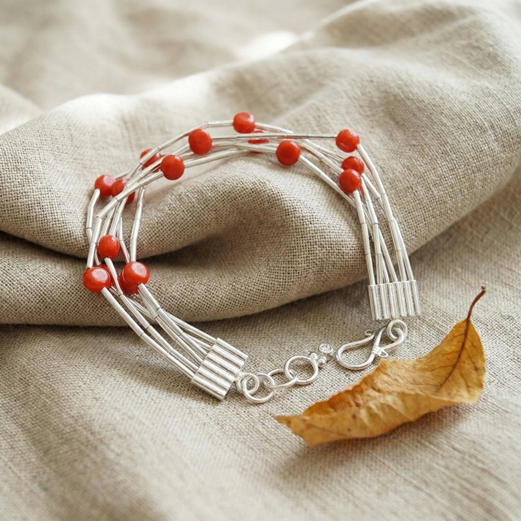 Red coral and 925 silver bracelet detail showing artisan craftsmanship, Bodrum atelier handmade jewelry inspired by Troy treasures