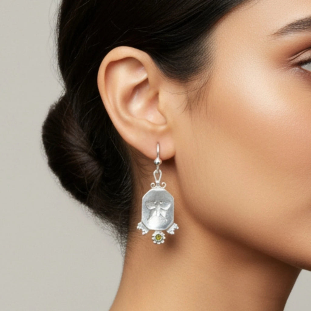 Handmade butterfly coin earrings detail with sterling silver finish showing artisan craftsmanship and vintage style
