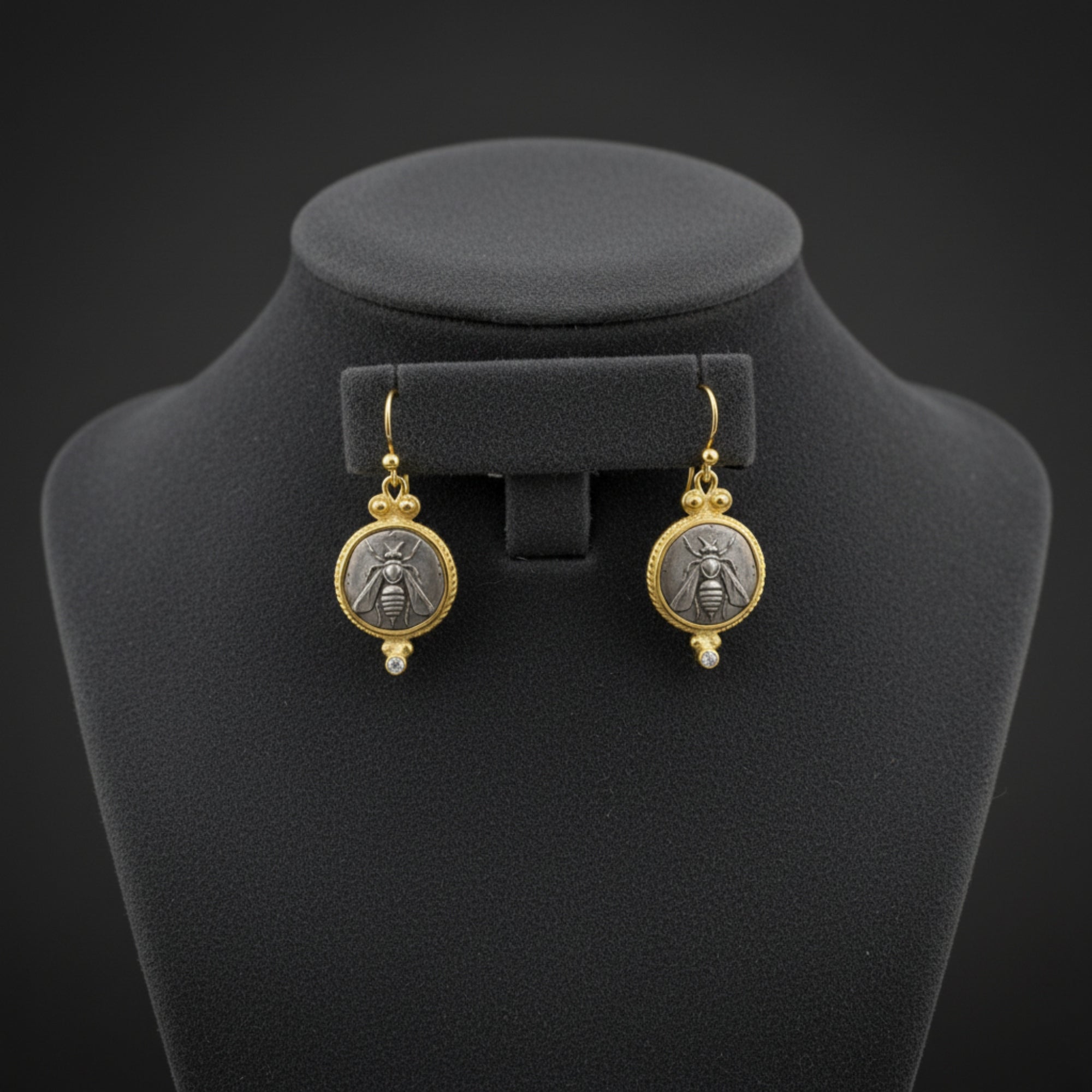 Close-up of Turkish artisan bee coin earrings with white topaz showing detailed 24K gold plating, handcrafted in Bodrum atelier
