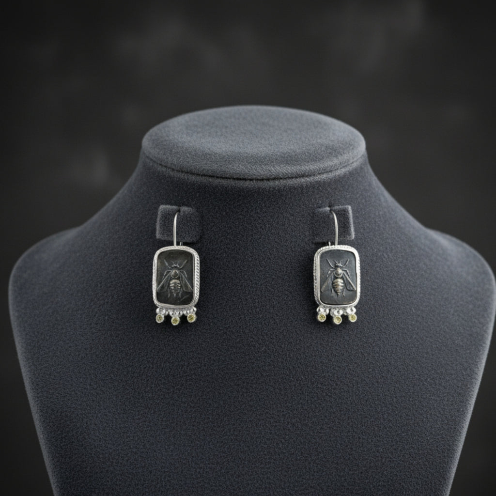 Artisan oxidized bee coin earring with canary topaz detail showing blackened sterling silver finish, handmade Turkish jewelry
