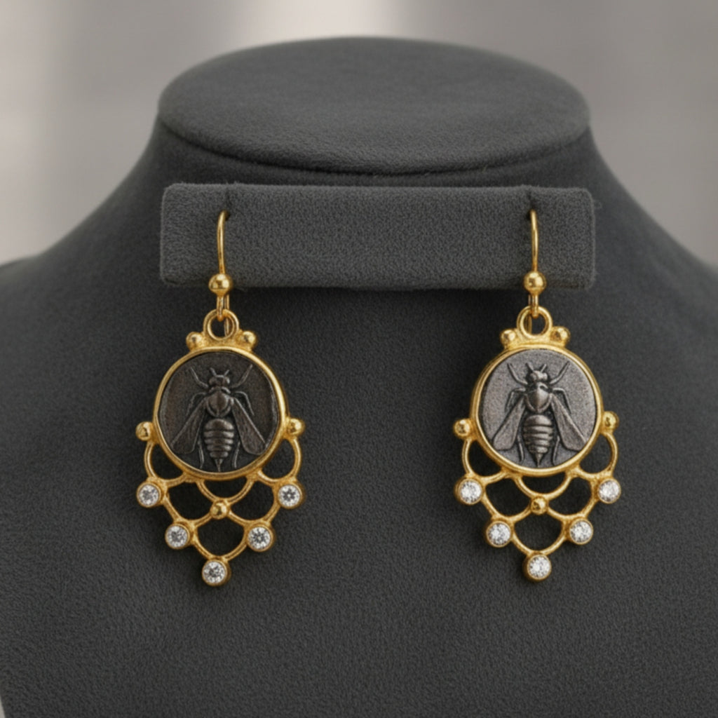 Close-up of Turkish artisan bee coin dangle earrings showing detailed 24K gold plating, handcrafted in Bodrum atelier
