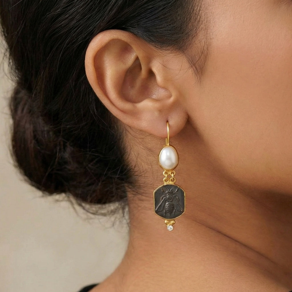 Close-up of Turkish artisan bee pearl dangle earrings showing 24K gold plating and natural pearl detail, handcrafted in Bodrum atelier
