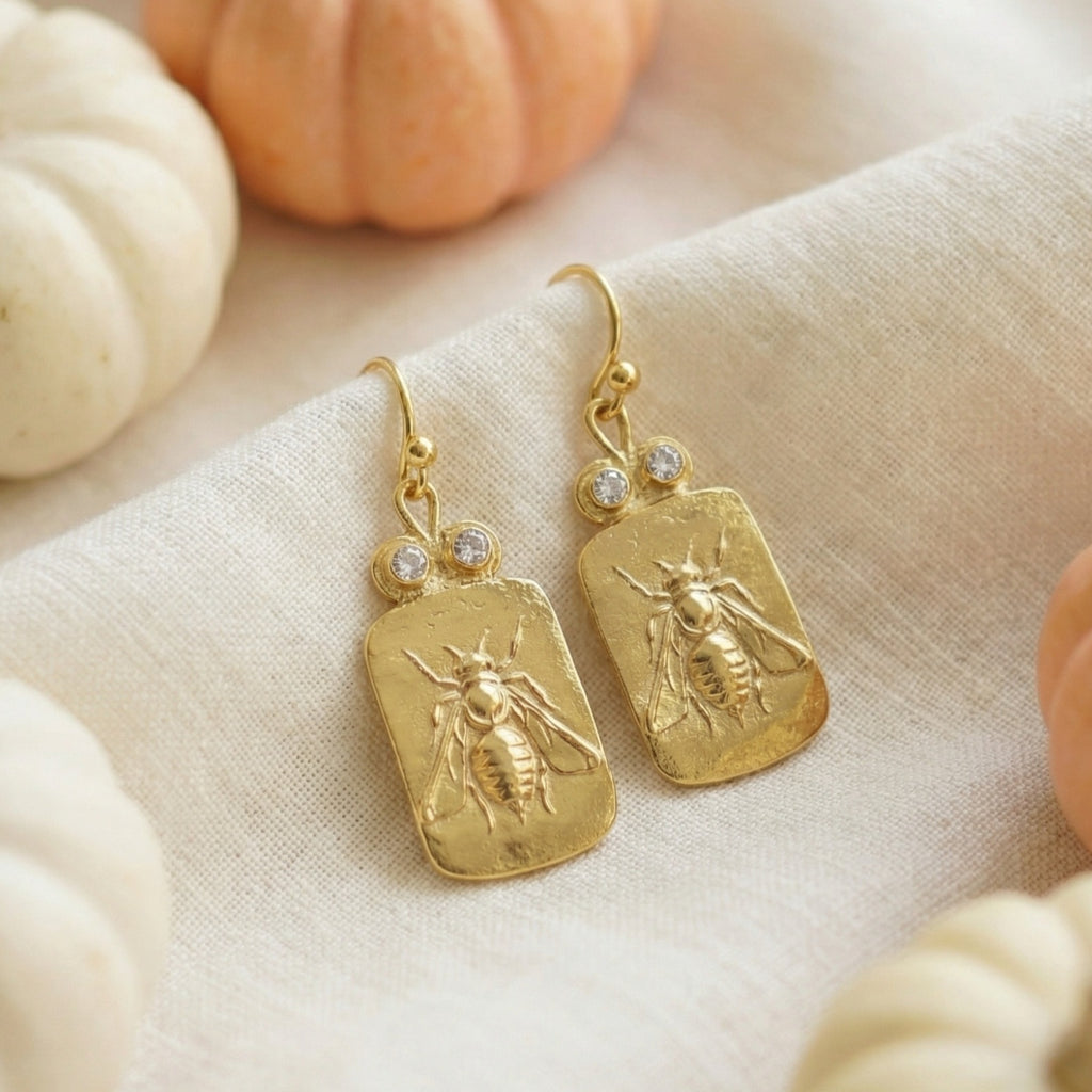 Artisan bee coin earring detail showing hammered texture and gold plating on sterling silver, handmade Turkish jewelry
