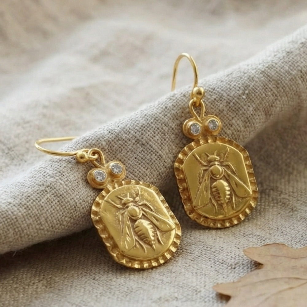 Gold bee white topaz earrings on model, 925 silver jewelry with ancient motif, perfect gift for women who love unique designer pieces
