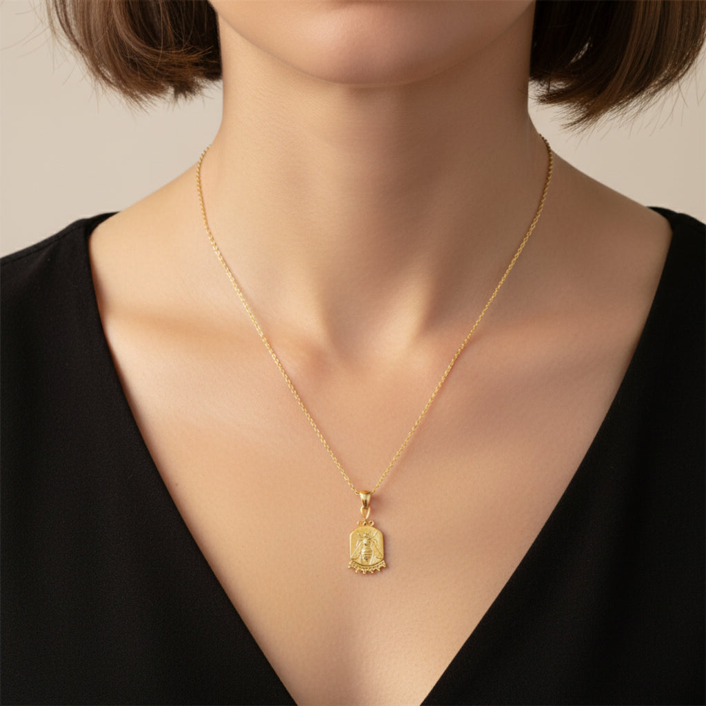 Close-up of Turkish artisan bee coin pendant showing detailed 24K gold plating, handcrafted in Bodrum atelier
