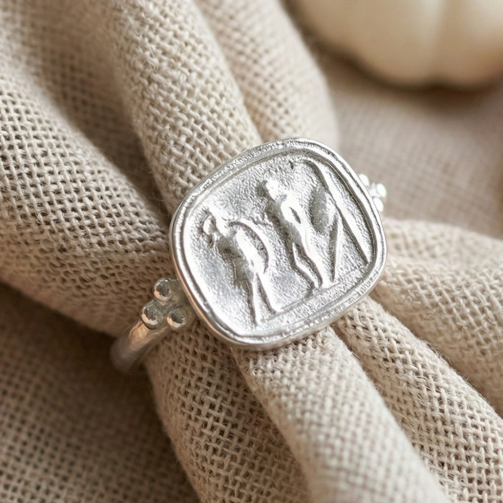 Roman art coin ring on hand, unique heritage design, symbol of history