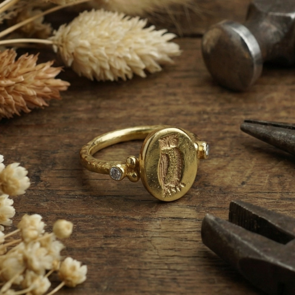 Designer owl coin ring detail showing 925 silver craftsmanship and natural white topaz setting