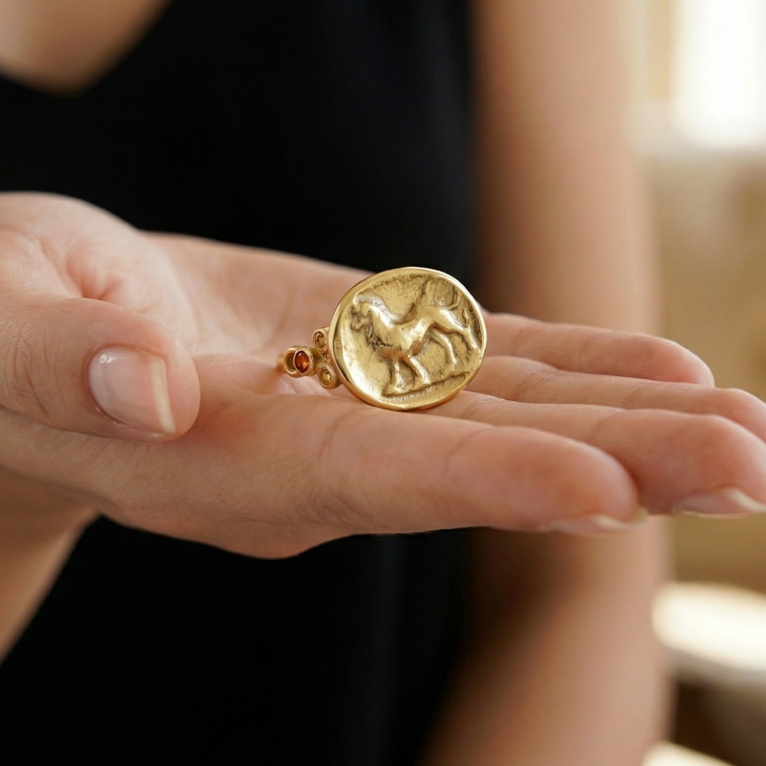 Designer lion coin ring detail showing 925 silver craftsmanship and natural orange topaz setting