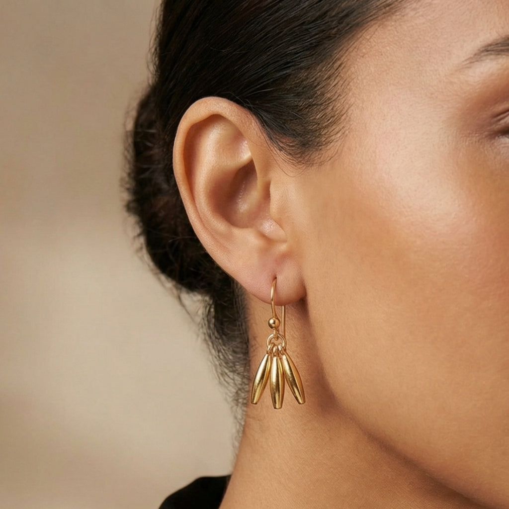 Close-up of minimalist linear earrings with 925 silver and 24k gold plating, handmade designer jewelry from AtelierSultan Bodrum
