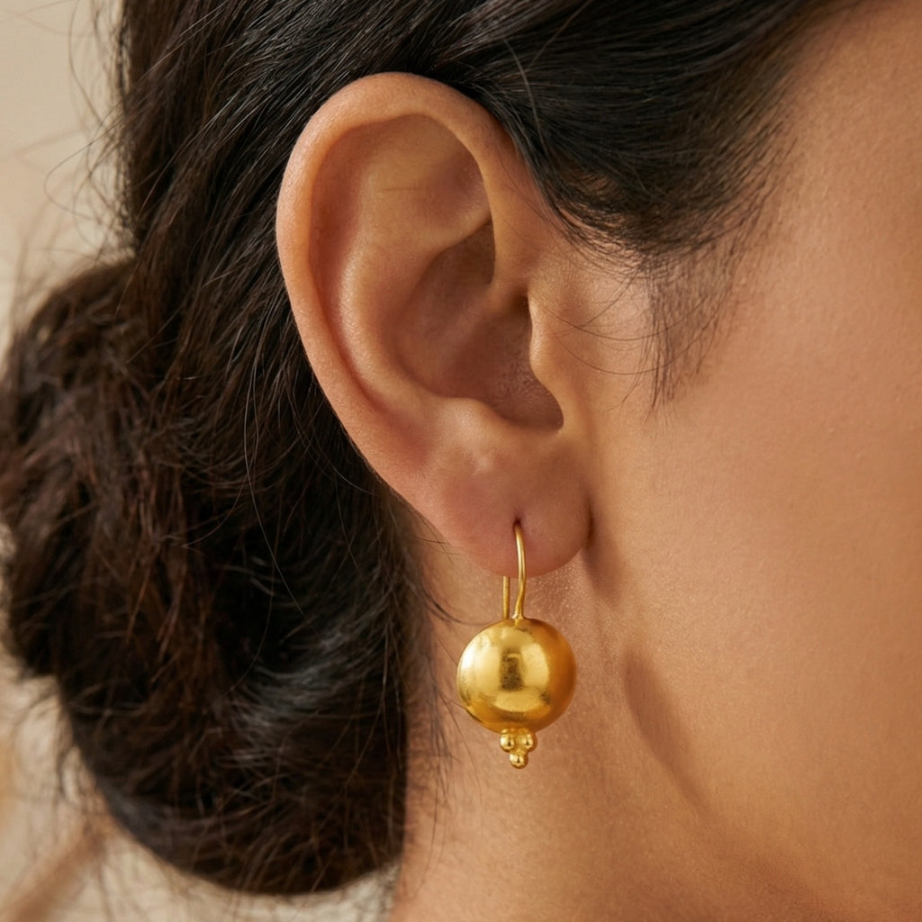Close-up of elegant round eternity earrings showing ancient-inspired design and 24k gold vermeil finish