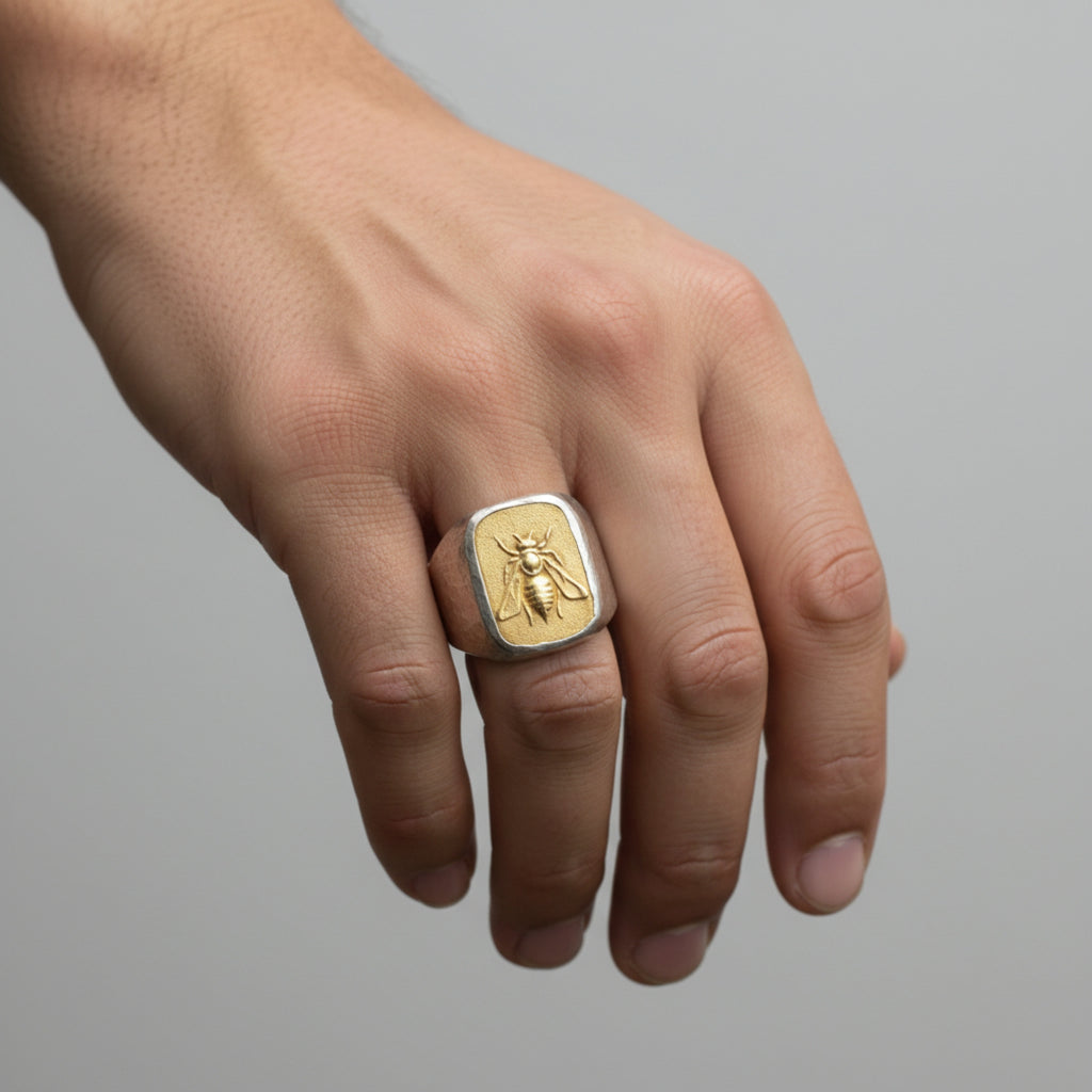Close-up of Turkish artisan gold bee coin signet ring showing detailed 24K gold plating and hammered texture, handcrafted in Bodrum
