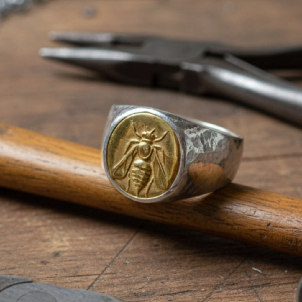 Close-up of Turkish artisan bee coin signet ring showing detailed 24K gold plating and hammered texture, handcrafted in Bodrum

