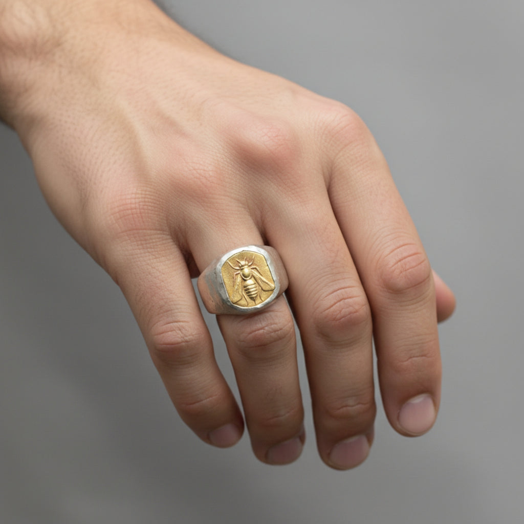 Close-up of Turkish artisan gold bee coin signet ring showing detailed 24K gold plating and hammered texture, handcrafted in Bodrum
