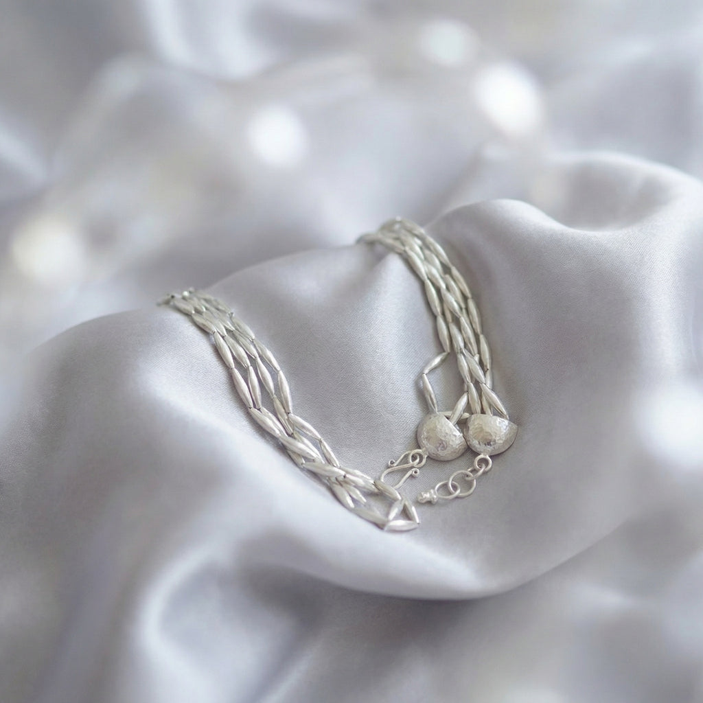 Three-row gold wheat necklace displayed on white background, featuring intricately handcrafted 925 silver beads with 24k gold plating