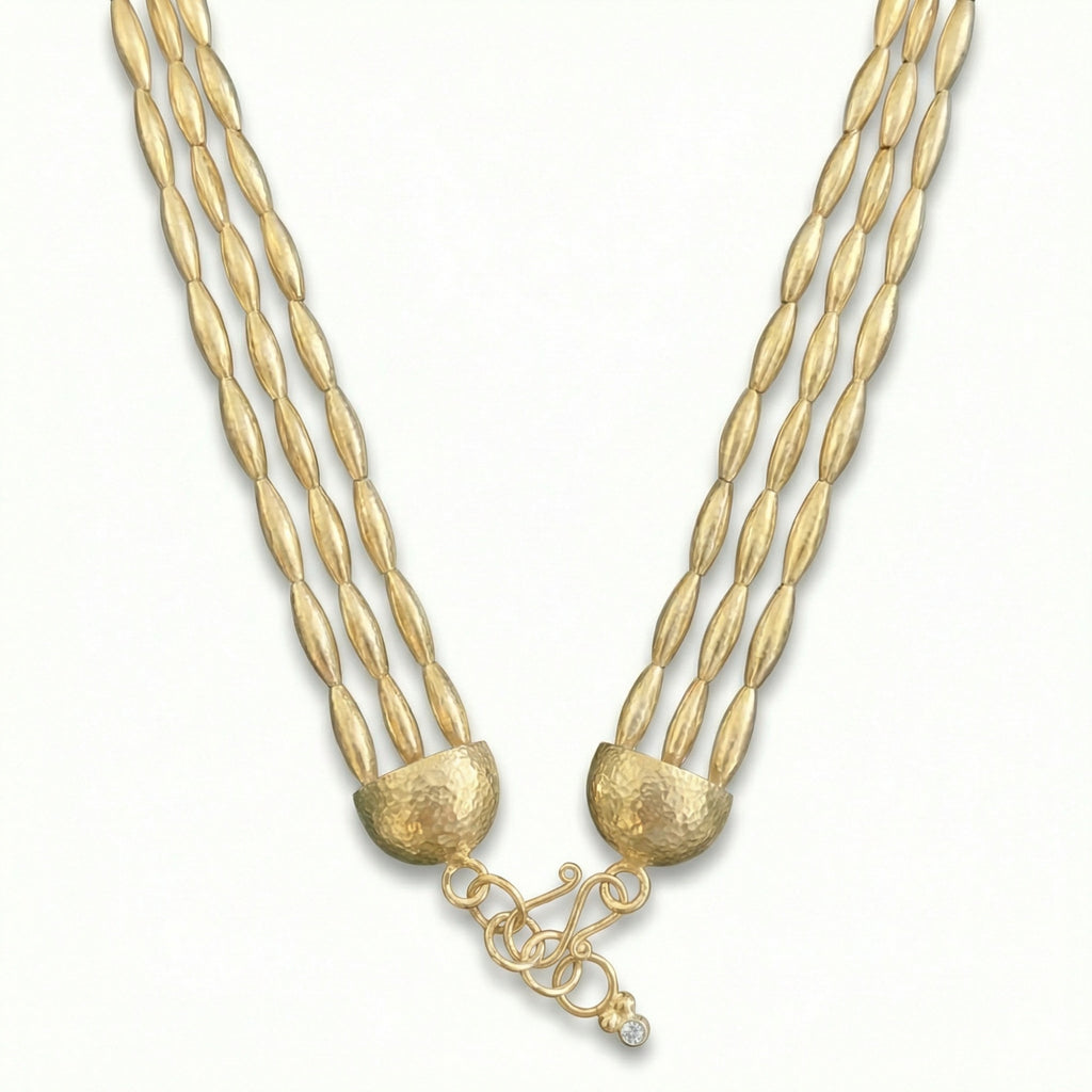 Three-row gold wheat necklace displayed on white background, featuring intricately handcrafted 925 silver beads with 24k gold plating