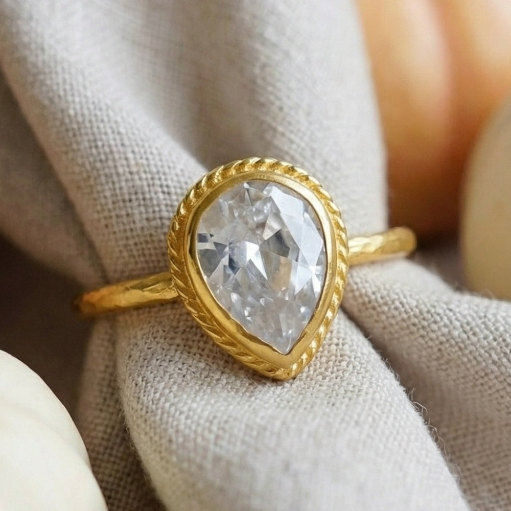 white topaz pear ring on hand, 925 silver jewelry with ancient motif, perfect gift for women who love unique designer pieces
