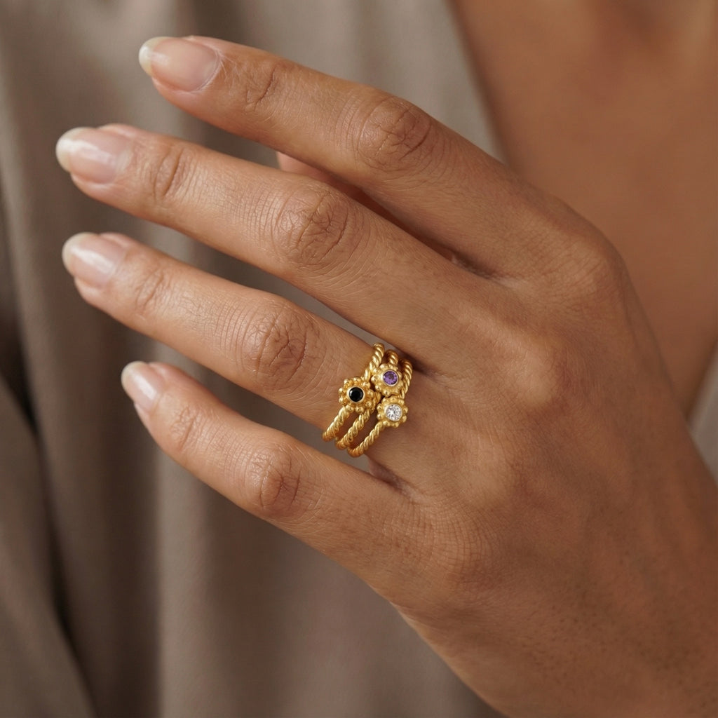 Close-up of Turkish artisan peridot amethyst stack rings showing detailed 24K gold plating and natural gemstones, handcrafted in Bodrum atelier
