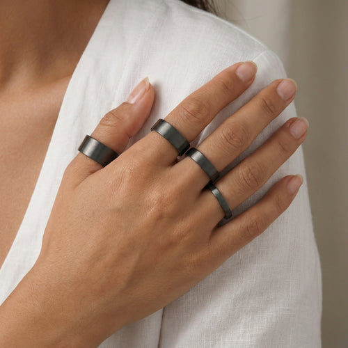 Elegant black satin wedding ring on hand showcasing contemporary Turkish design from Bodrum studio, meaningful gift for LGBTQ+ weddings and commitment ceremonies